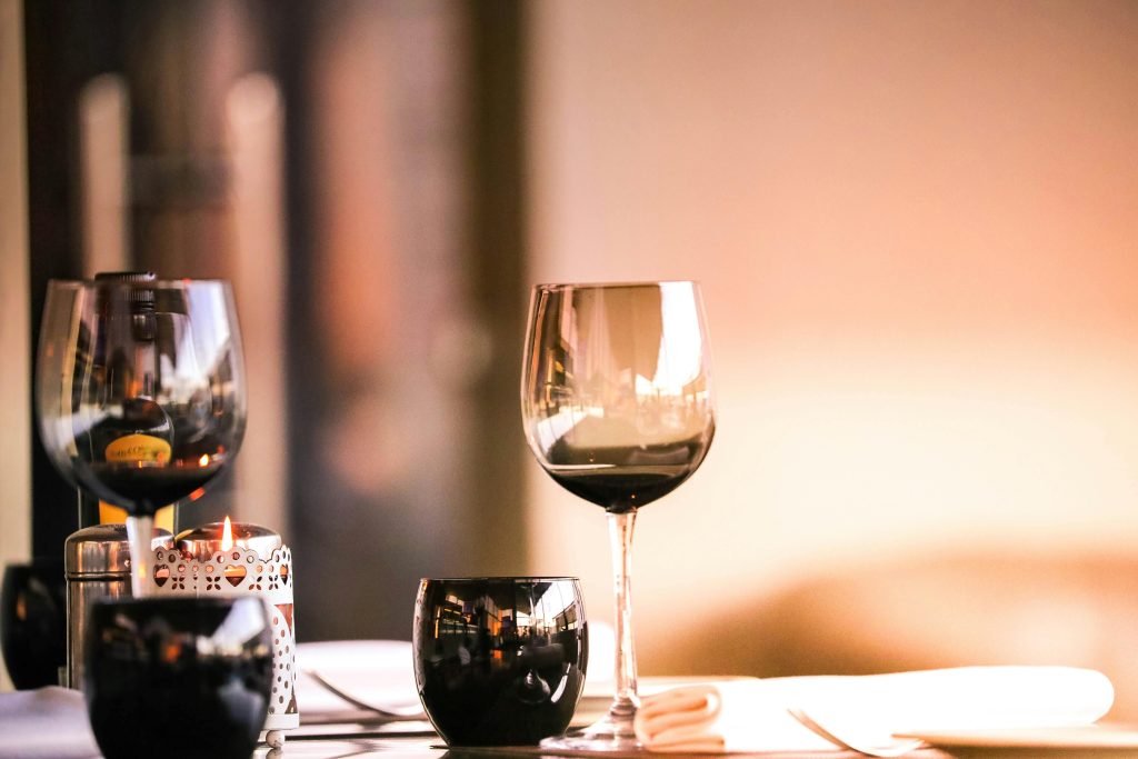 Elegant setup with wine glasses and a candle, perfect for dining ambiance.